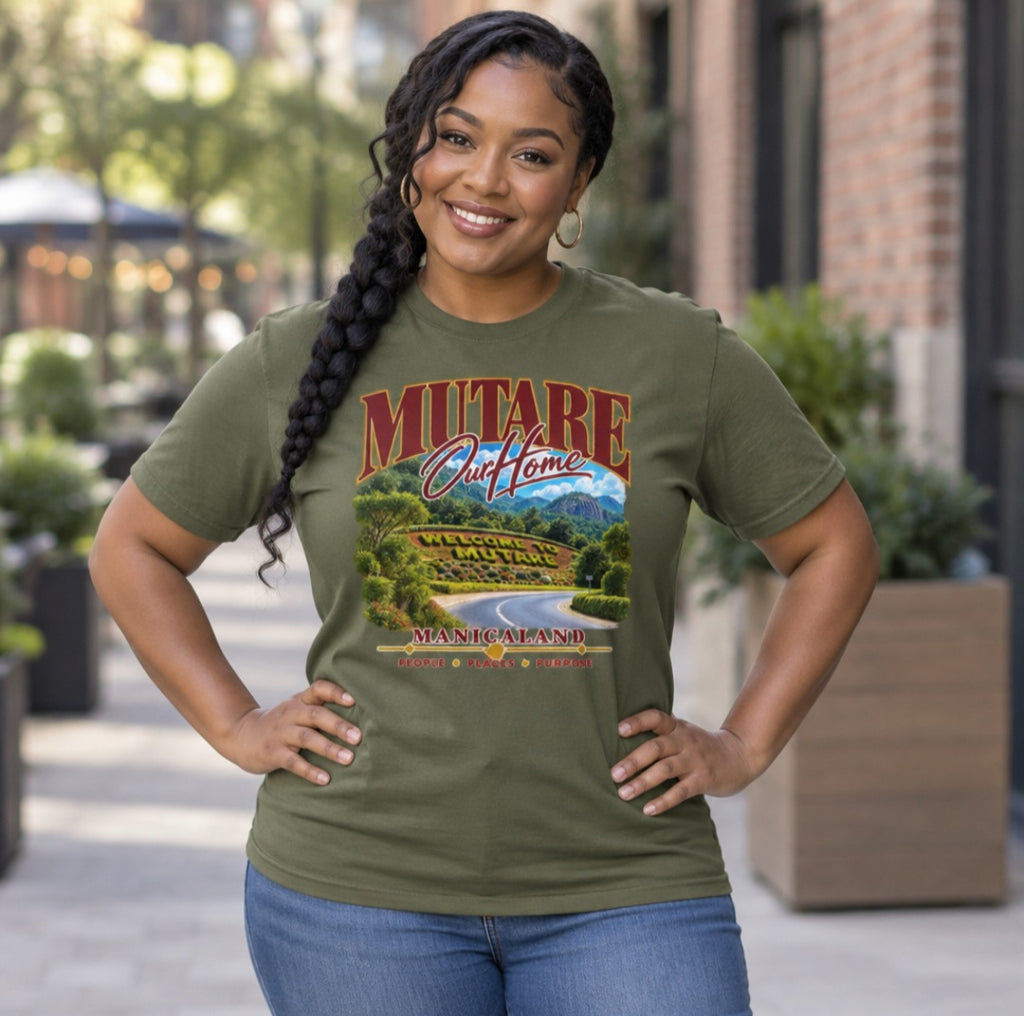 Woman wearing a hemp-coloured Sister Style Mutare t-shirt outdoors, with scenic road artwork and “Mutare Our Home” lettering.