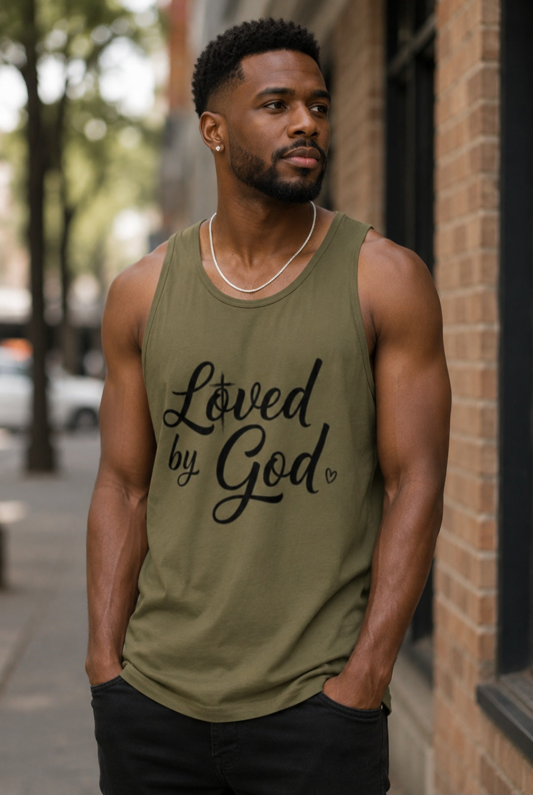 Man wearing olive Loved by God tank top on city street – Sister Style Christian Faith Streetwear