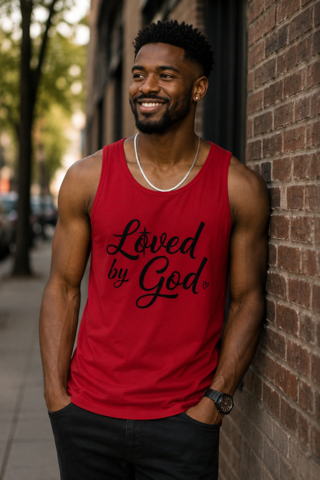 Man wearing red Loved by God tank top smiling outdoors – Sister Style Christian Faith Streetwear