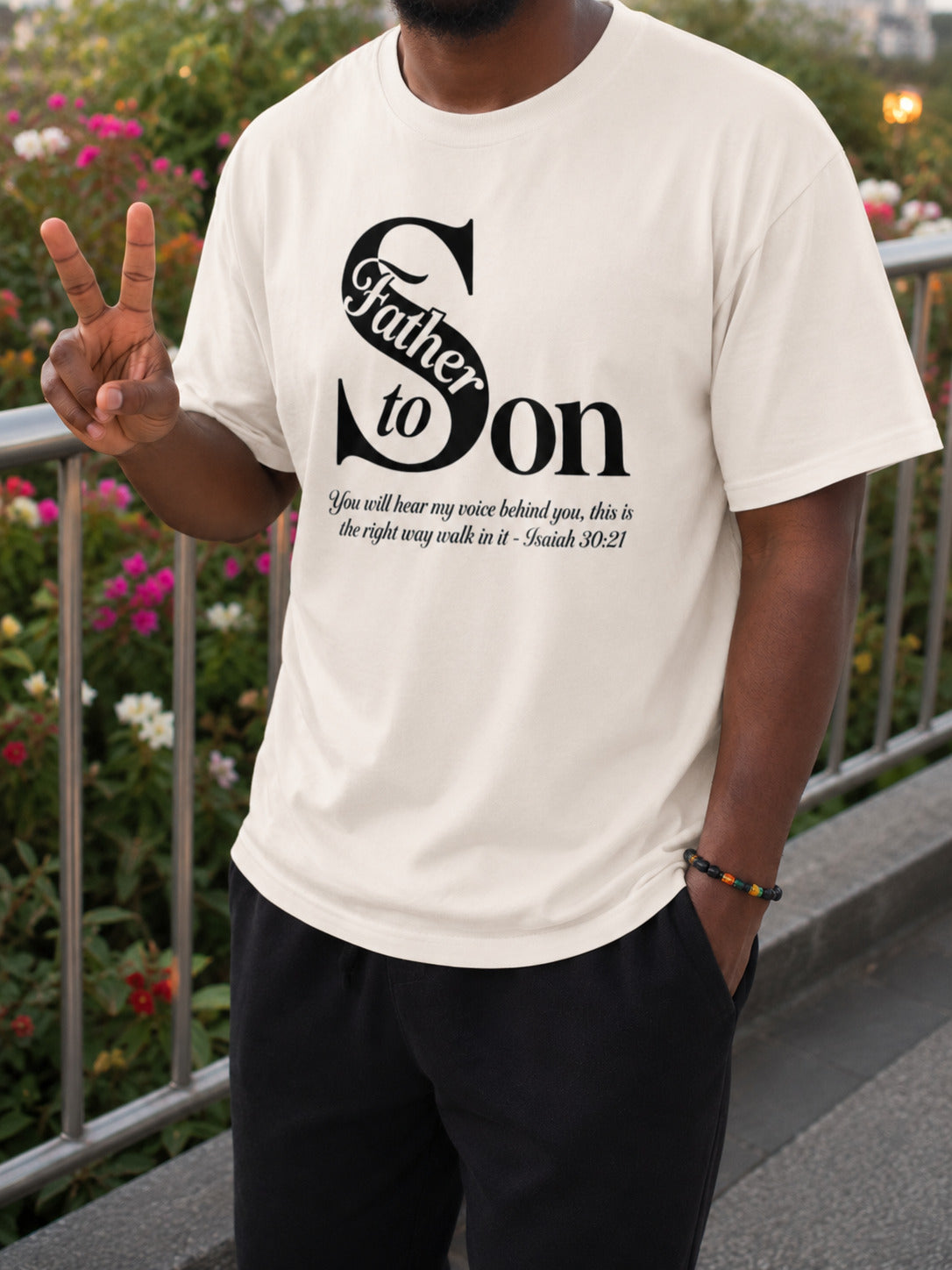 Man wearing the Father to Son Tee by Sister Style — Isaiah 30:21 Christian faith streetwear African heritage