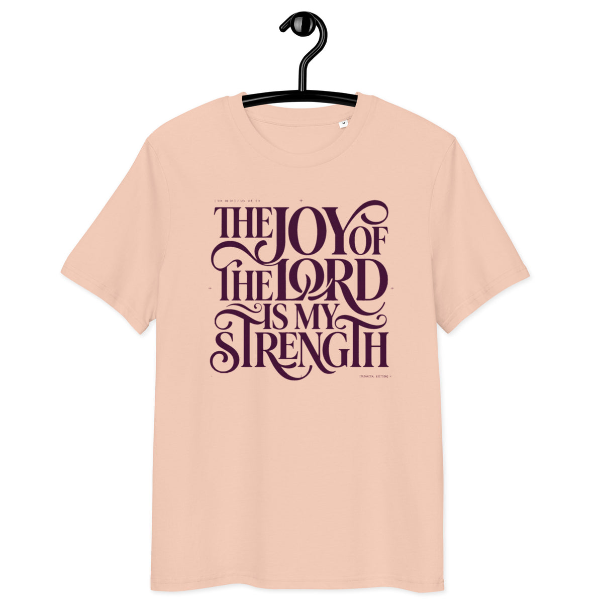 Front view of Fraiche Peche Joy of the Lord t-shirt on a hanger, with “The Joy of the Lord Is My Strength” in dark flowing lettering.