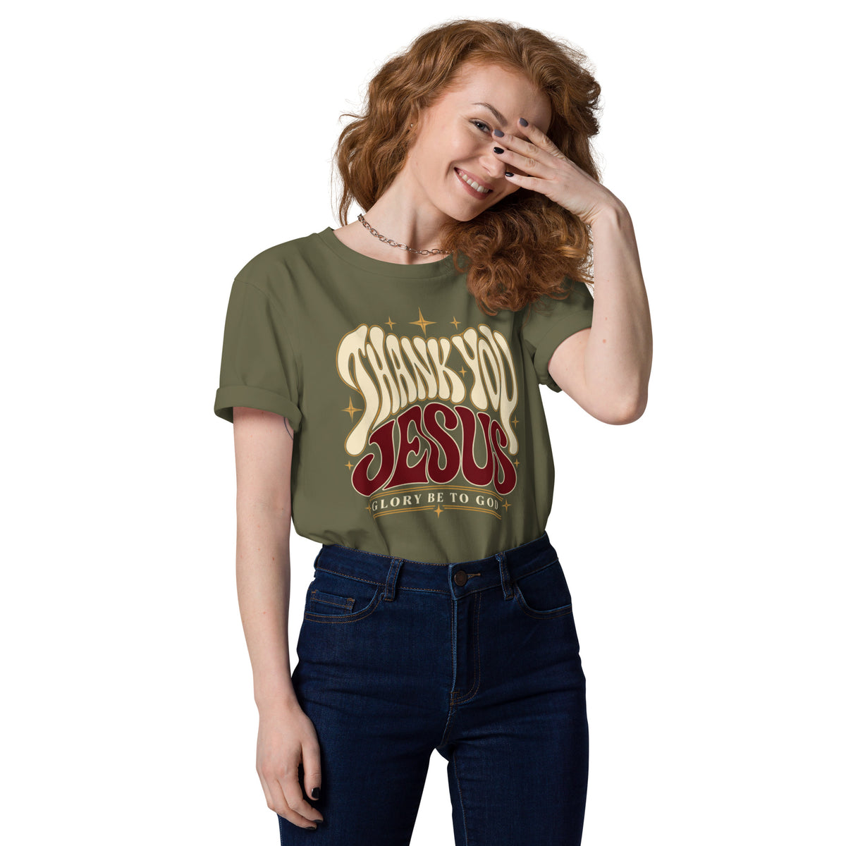Woman wearing a Khaki Thank You Jesus organic cotton t-shirt tucked into jeans, with retro lettering and star accents.
