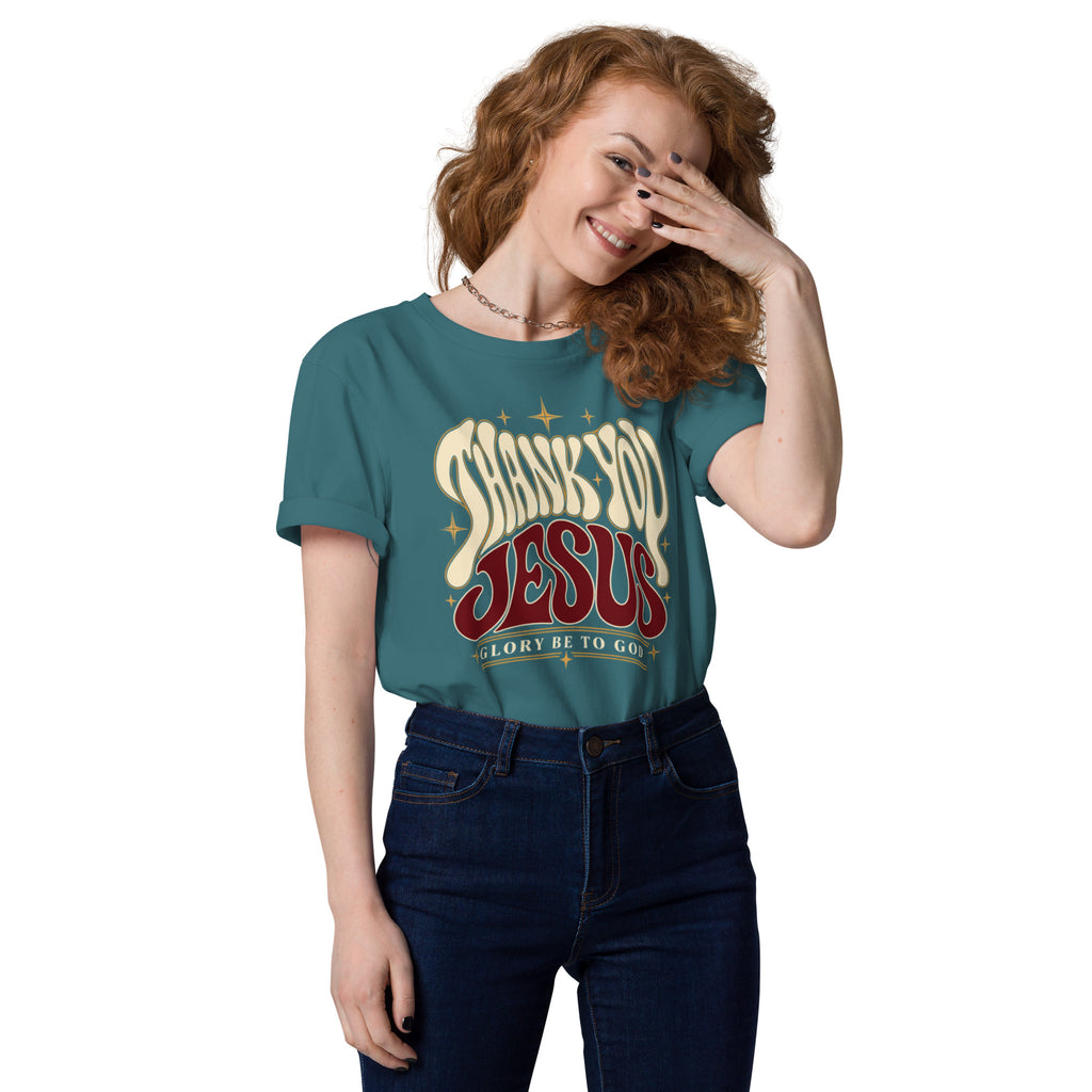 Woman wearing a Stargazer Thank You Jesus organic cotton t-shirt tucked into jeans, with retro lettering and star accents.